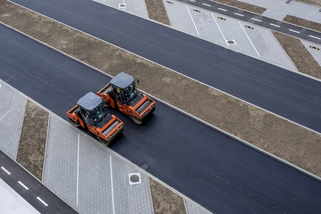 aerial-view-orange-vibratory-asphalt-roller-compactor-new-pavement_181624-49122-1