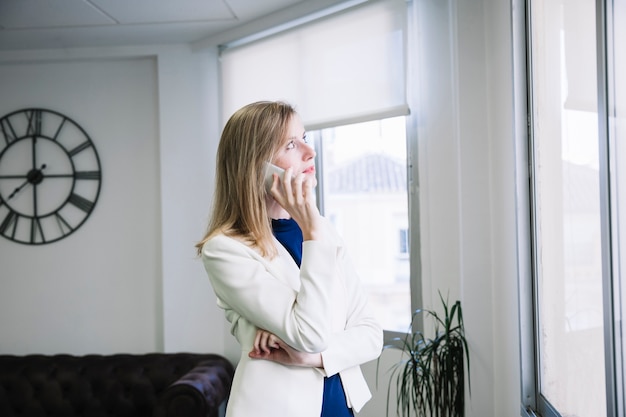 businesswoman-phoning-office_23-2147705251