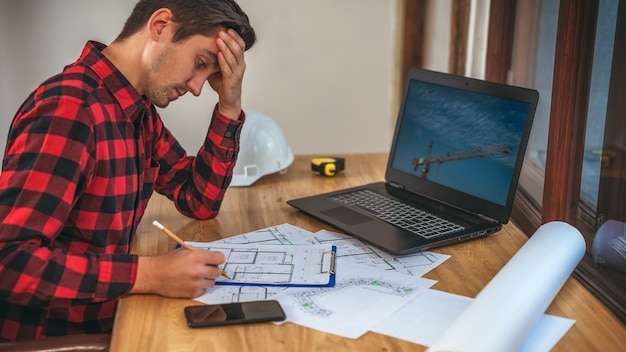 civil-engineer-desk-working-with-documents_207949-513