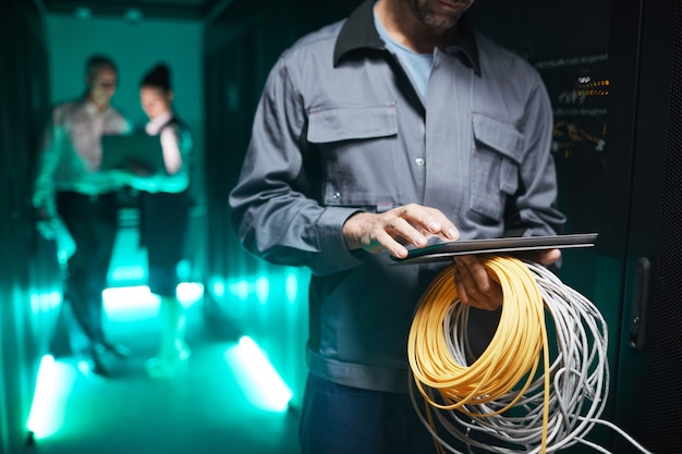 cropped-shot-network-engineer-using-digital-tablet-server-room-maintenance-work-data-center-copy-space_236854-32615