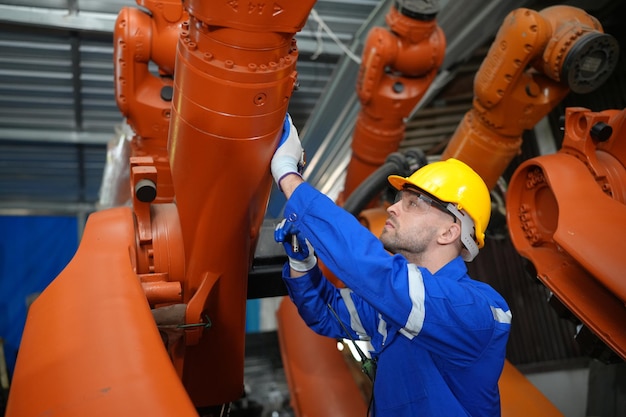 engineer-man-working-industrial-robot-factory-industrial-robotics-digital-manufacturing-operation_35752-14577