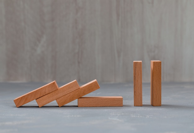 falling-standing-wooden-blocks-plaster-wooden-table_176474-7028