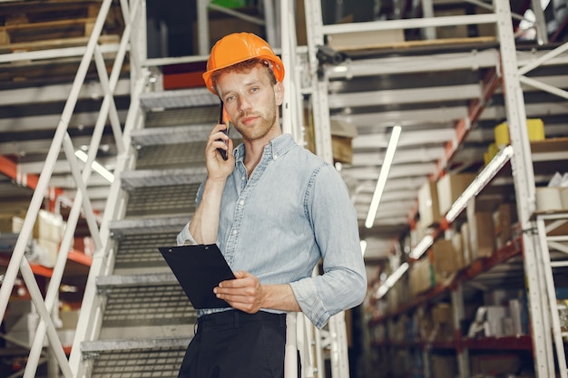 industrial-worker-indoors-factory-businessman-with-orange-hard-hat-man-blue-shirt_1157-40903