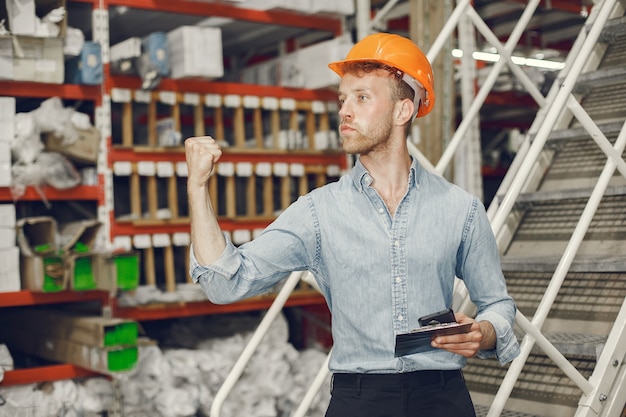 industrial-worker-indoors-factory-businessman-with-orange-hard-hat-man-blue-shirt_1157-40906-1