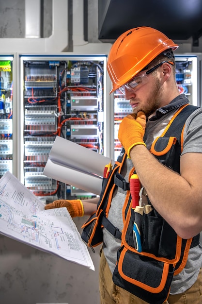 male-electrician-working-electrical-panel-male-electrician-overalls_169016-67232
