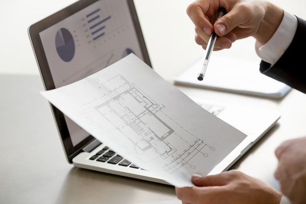 male-hand-holding-project-plan-statistics-screen-close-up_1163-5283