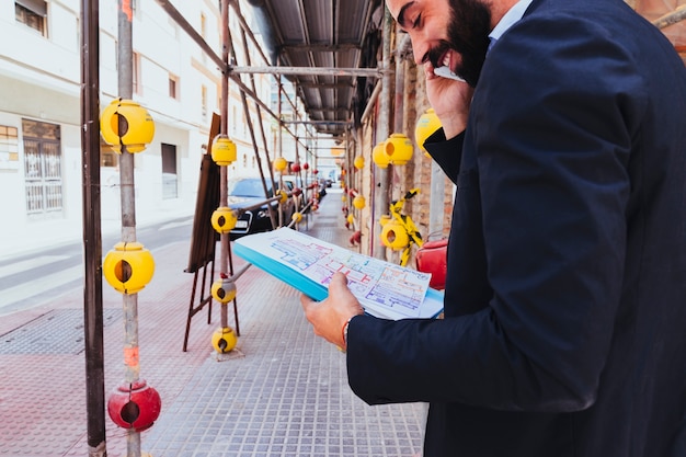 smiley-businessman-talking-phone_23-2147650217